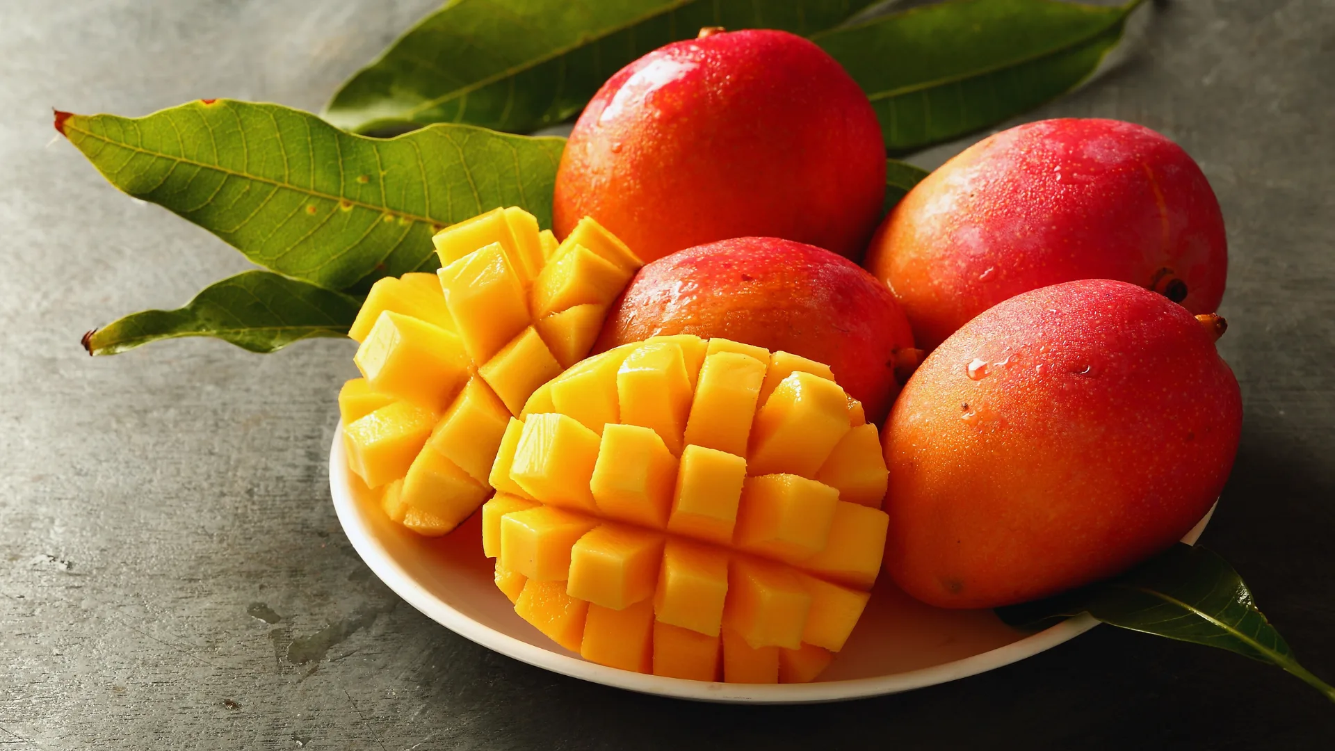 Sliced mango neatly arranged on a plate.